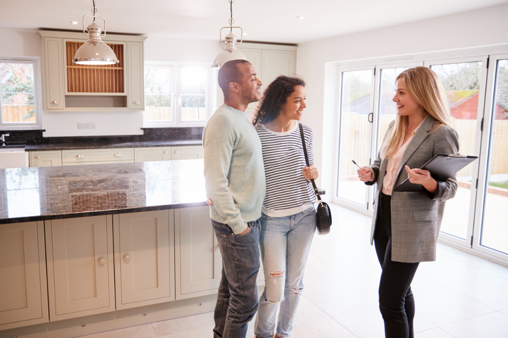 Female Realtor Showing Couple The House